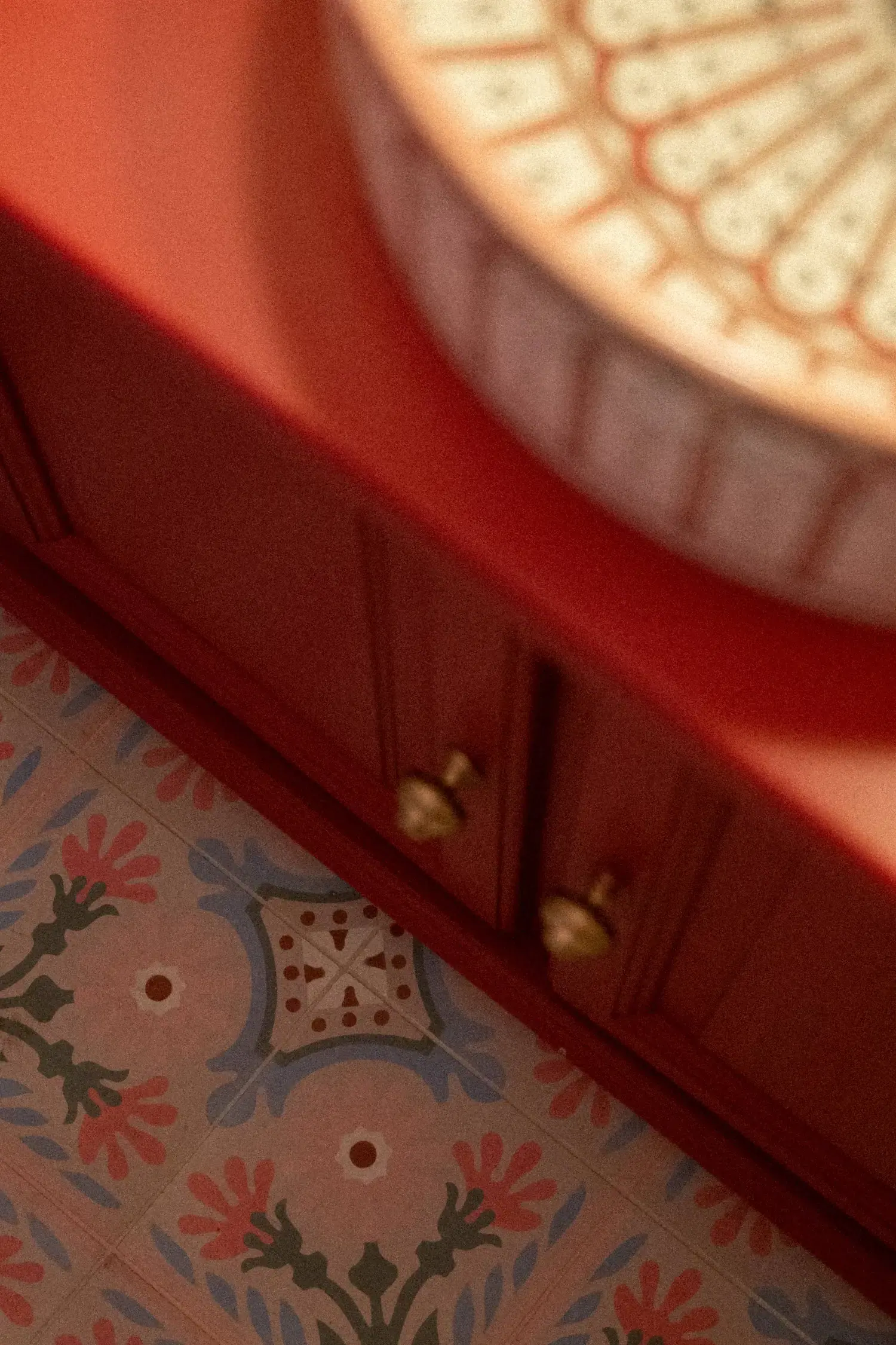 Flagey — vermilion cabinet and gold knobs